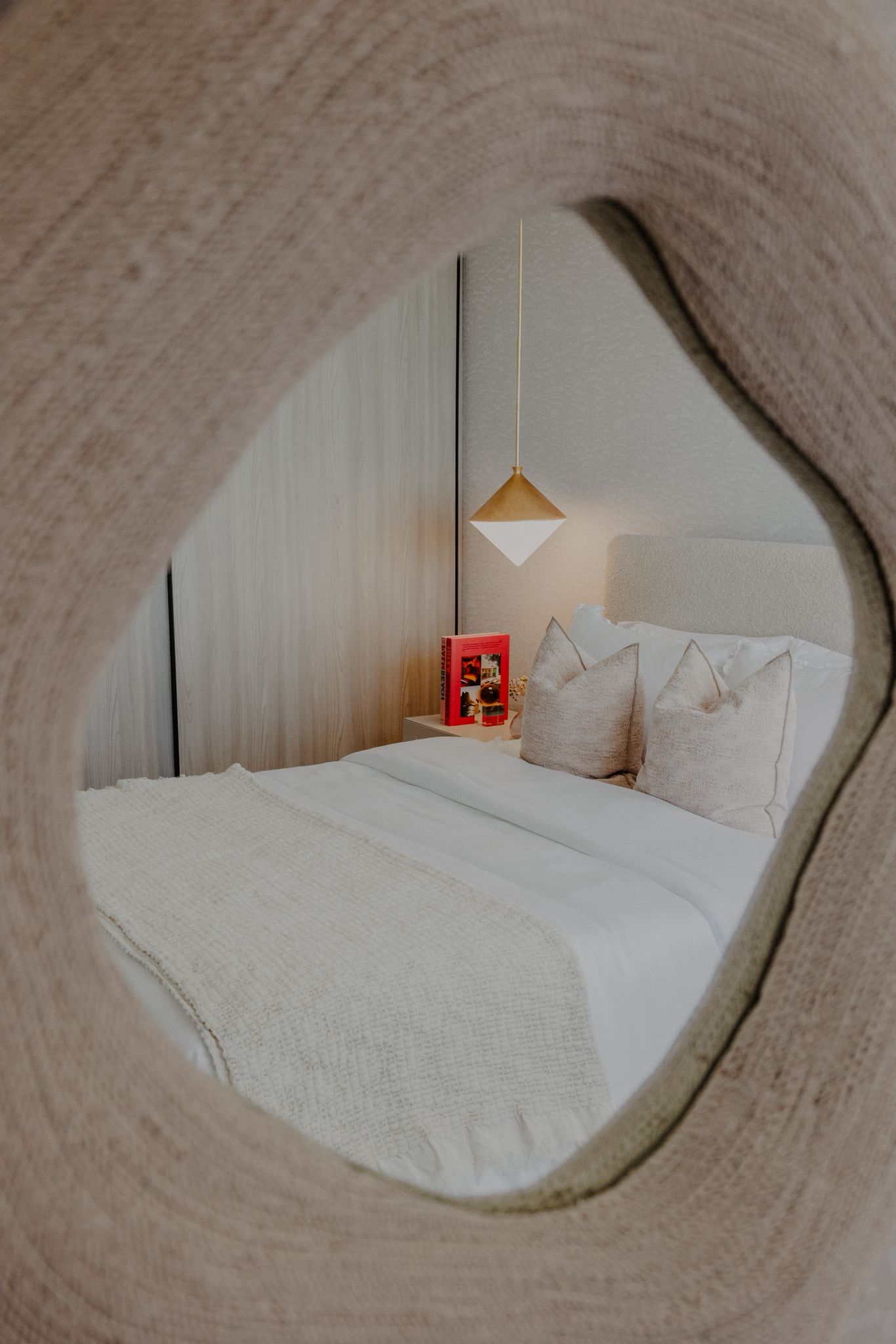 Reading nook with single brass lamp.